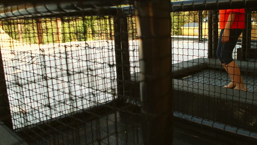 9-10 years old girl jumping on inflatable rubber playground and smiling. Recreation outdoors for kids. 4k slow motion