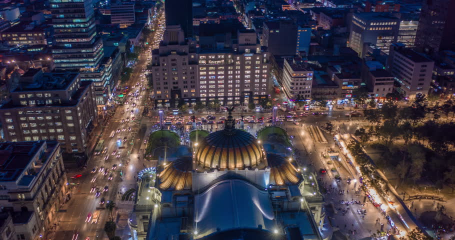 Aerial nocturnal hyperlapse of the Palacio de Bellas Artes, Eje Central street and the Madero pedestrian street at night. Mexico City