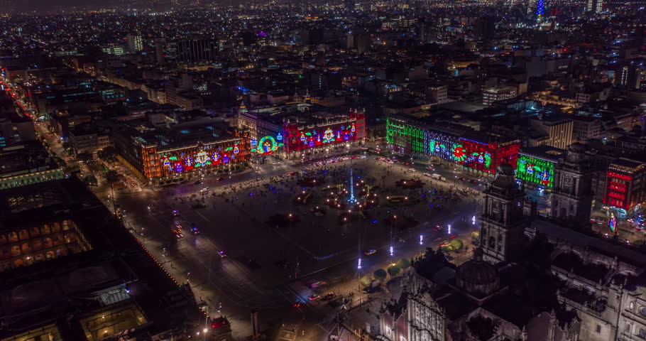 Aerial nocturnal hyperlapse of the main plaza of Mexico City know as El Zocalo with Christmas lights at night. Mexico City