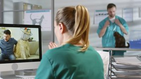 Handheld tracking shot of female veterinary specialist in scrubs sitting at her desk and giving consultation to male dog owner via video call. She is talking about nutrition and asking questions