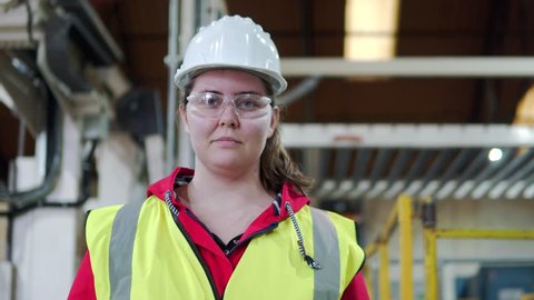 Portrait Of A Happy, Hard Working Woman, Female Industrial Worker In Factory.