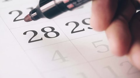 Drawing red circled mark on the twenty-eighth 28 day of a month in the calendar