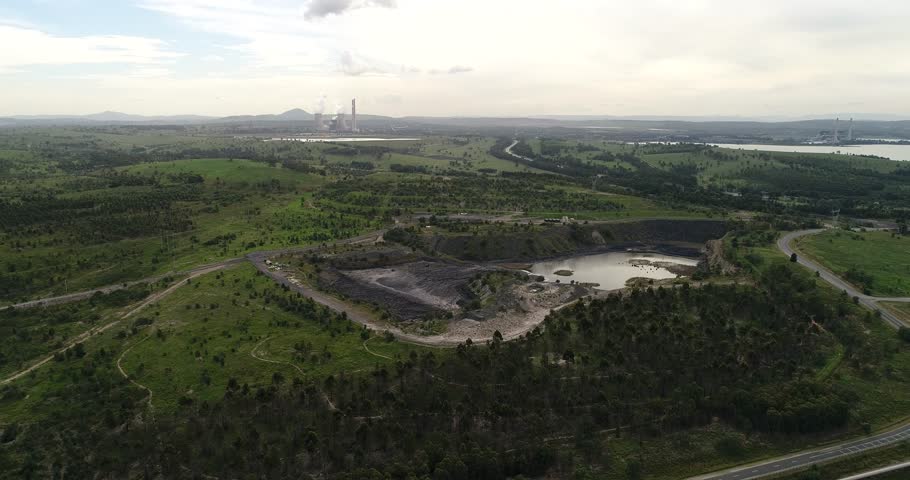 Black coal open cut mines in Hunter Valley region of NSW, Australia. Elevated aerial hovering above excavation sites and bayswater power station.

