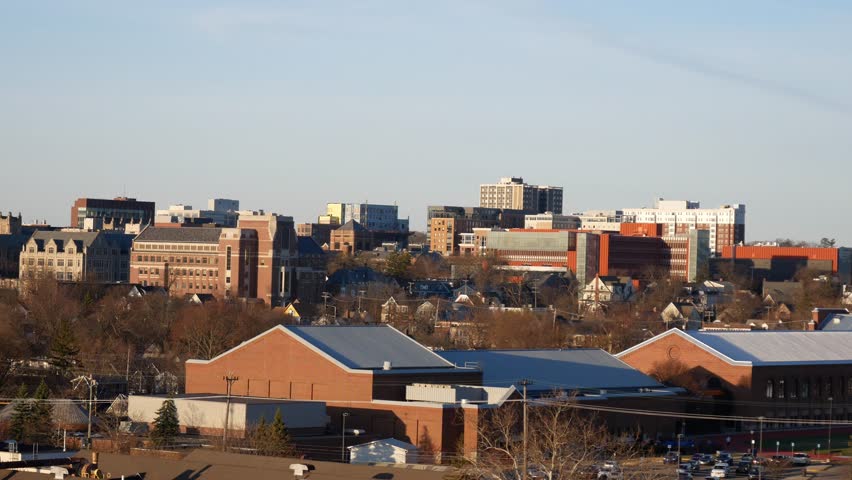 The view of the cityscape of Ann Arbor, Michigan during sunset on a clear day.