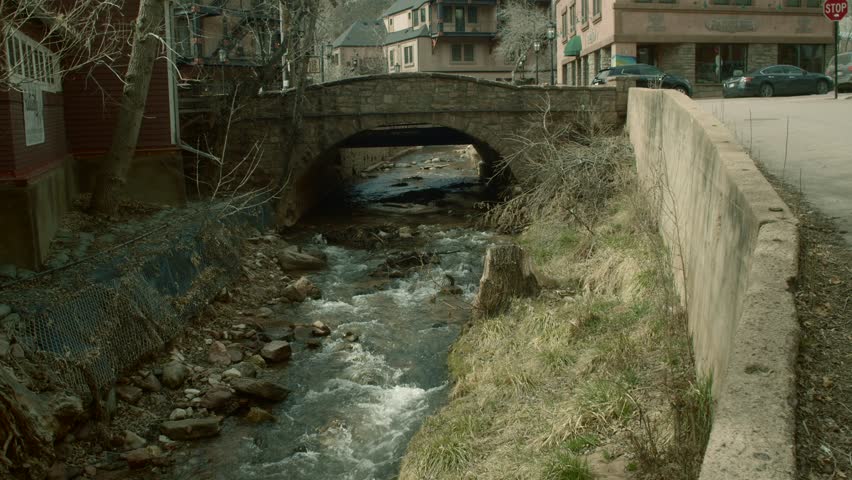 Stone bridge over babbling brook in old mountain town