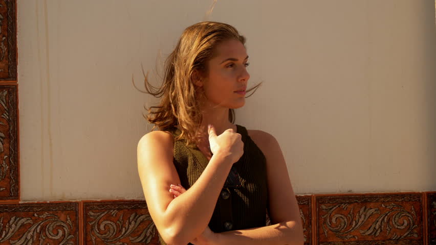 Portrait shot of a beautiful brunette model with a wind blown hair.