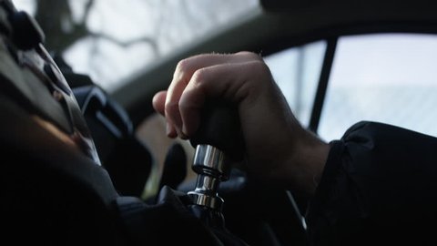 Male hand driving van, interior shot. Driving with hand on gear stick and change gear