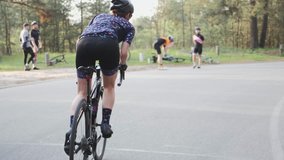 Cycling Woman on bicycle. Cycling training. Female cyclist sprinting out of the saddle. Cycling training concept. Uphill cycling ride