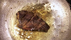 Asian style fish fried in frying pan with very hot oil top view footage