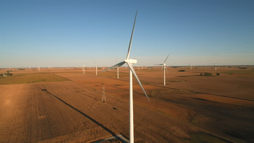 Remote windfarm in large field at sunset  | Shutterstock HD Video #1028486849