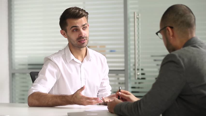 Male advisor salesman talking with client handshaking closing deal at business meeting, hr hire applicant at job interview, customer thanking manager for advice shake hands make agreement concept | Shutterstock HD Video #1028495336