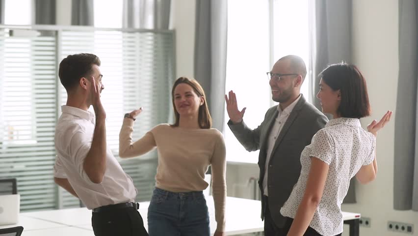 Happy leader motivate diverse employees business team give high five together, excited office workers group and coach engaged in teambuilding celebrate success good results reward in teamwork concept Royalty-Free Stock Footage #1028495393