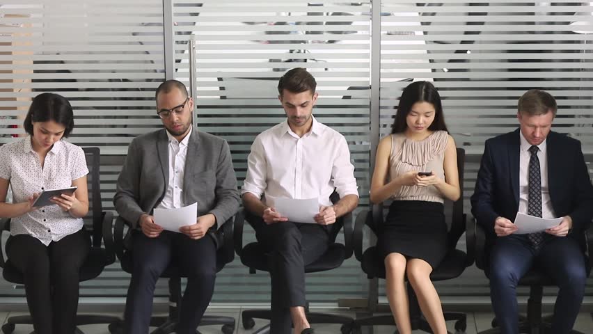 Multicultural business people applicants in row line queue prepare waiting for their turn on job interview, diverse unemployed vacancy seekers group sit on chairs, human resources employment concept Royalty-Free Stock Footage #1028495408