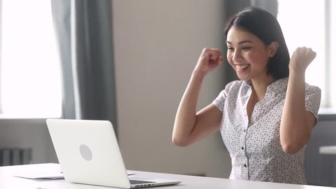 Overjoyed happy asian business woman winner looking at laptop computer excited by great professional work result success, motivated office worker receive good news online win opportunity get promoted