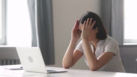 Stressed tired asian businesswoman worker using laptop having computer problem upset about mistake at workplace, overworked female employee working online frustrated about business failure in office