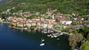 Aerial drone video of iconic village of Ossucio and small islet of Comacina in lake Como one of the most beautiful and deepest in Europe, Lombardy, Italy