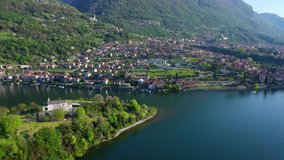 Aerial drone video of iconic village of Ossucio and small islet of Comacina in lake Como one of the most beautiful and deepest in Europe, Lombardy, Italy