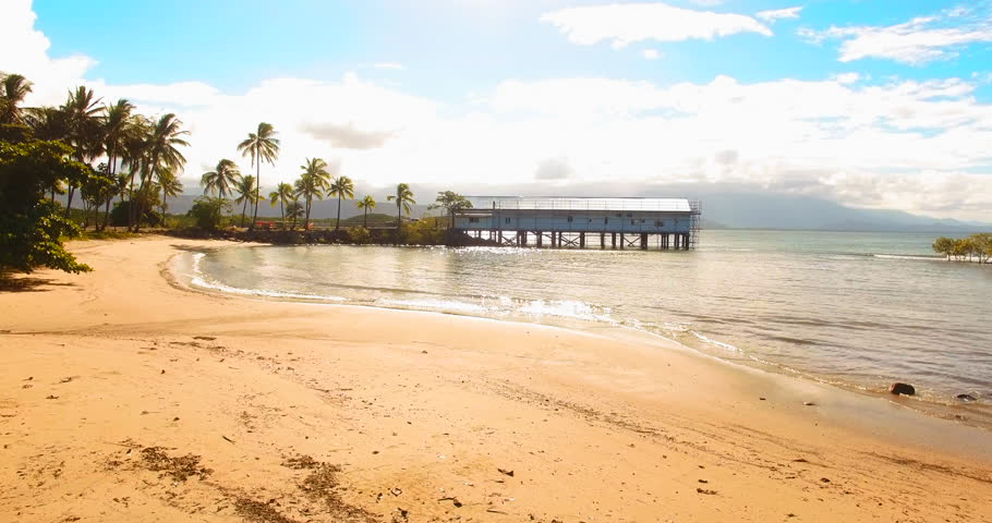 Gliding over Port Douglas Beach with golden sand