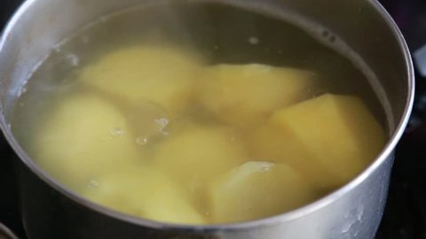Cooking potatoes in a pan. Close up. Boiling water
