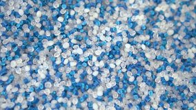 Virgin plastic pellets with blue pigment pellets. Plastic Material for molding machine and plastic injection machine. Industrial engineering concept