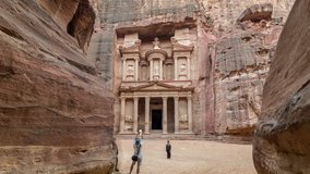 The Siq, a narrow canyon with vertical walls and a main entrance to Petra.  It ends at Petra's most famous ruin, Al Khazneh or the Treasury. Time lapse video. Long exposure, no recognizable faces