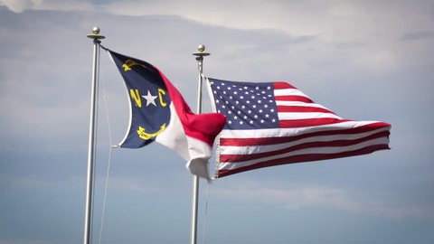 The state flag of North Carolina flies alongside the stars and stripes.