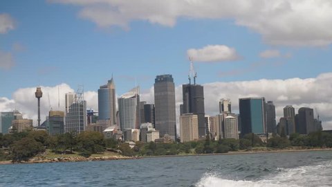 Wide shot of the Sydney CBD skyline from the harbor on a boat.