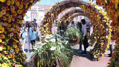 TIMISOARA, ROMANIA - April 19, 2019: Liberty Square, TIMFLORALIS international flower festival. People and tourists are taking pictures near flower decorations