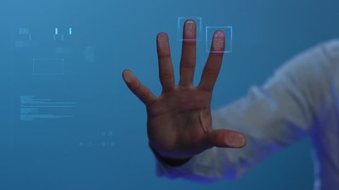 The person clicks on the fingerprint scanner, which is executed in the style of the digital future. The digital world and technology. For digital applications and solutions. Slowmotion. Shot on Arri