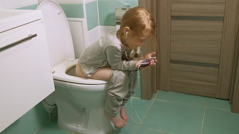 Similar Stock Videos of little girl in pajamas sits on the toilet