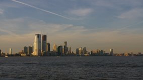 Famous Skyline Buildings In New York City From The Hudson Manhattan Ferry, USA. Hudson River. Freedom Tower. Establishing Shot .Tourist Attraction. Golden Hour. 