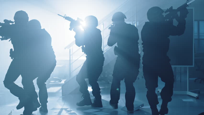 Close Up Portraits of Masked Squad of Armed SWAT Police Officers Storm a Dark Seized Office Building with Desks and Computers. Soldiers with Rifles and Flashlights Move Forward and Cover Surroundings. | Shutterstock HD Video #1028544554