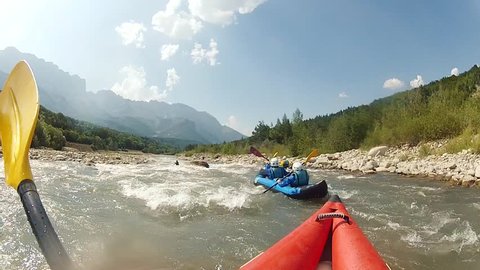 POV shot of rowing. Rafting with first-person view. Action camera in water sports. Water spray on camera.