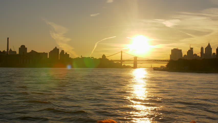Skyline Buildings At Beautiful Sunset In New York City From The Hudson Manhattan Ferry, USA. Freedom Tower From Hudson River. Establishing Shot . Sun Beaming Down River. Tourist Attraction Royalty-Free Stock Footage #1028546330
