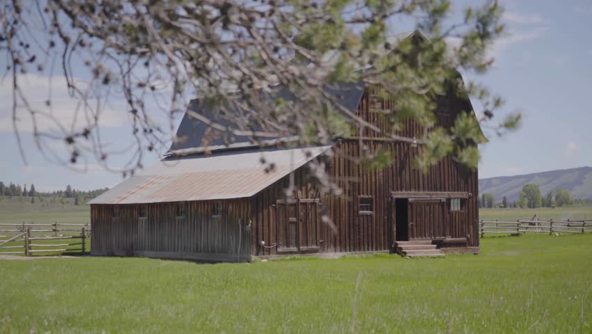 Barn in a Green Pasture Tracking Shot