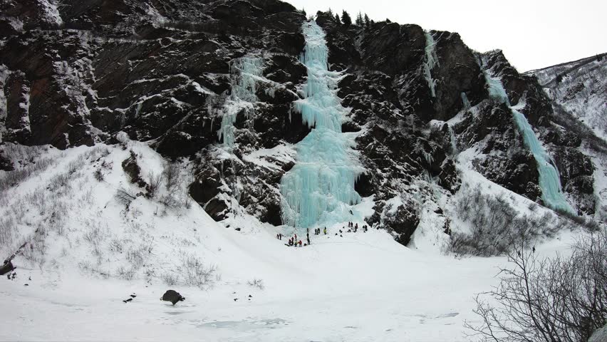Snowy icy mountain in Valdez Alaska with alpine climbers mountaineering, time lapse shot