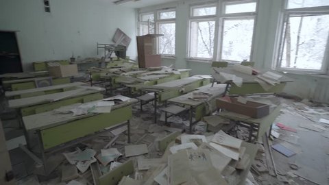 Trucking Pan of Abandoned Classroom with Scattered Papers in Pripyat