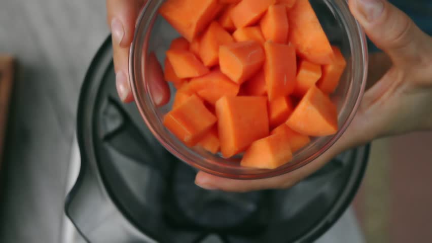 Female Hands Add Carrot into Blender to Cook Vegetable Sauce. Top View, Vegan and Vegeterian Food. Lifestyle of Health and Sustainability Concept