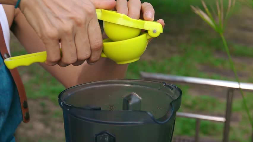 Female Hands Squeeze Lime into Blender to Cook Vegetable Sauce. Side View, Vegan and Vegeterian Food. Lifestyle of Health and Sustainability Concept