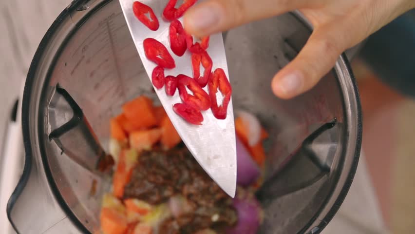 Female Hands Add Spicy Red Chili Pepper into Blender to Cook Vegetable Sauce. Top View, Vegan and Vegeterian Food. Lifestyle of Health and Sustainability Concept