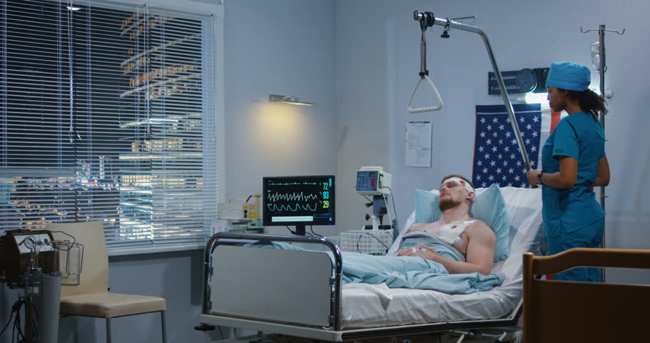 Medium shot of doctor visiting injured soldier in hospital and giving instructions to nurse