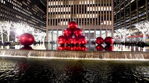NEW YORK CITY - DECEMBER 7, 2018: Christmas Balls and Midtown Manhattan skyscrapers with night lights, view from the street.