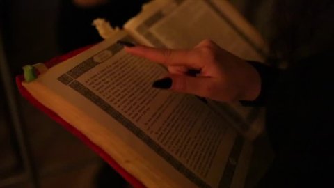 The witch runs her finger over the book video footage