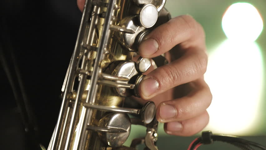 The artist plays the saxophone. Fingers press the keys of the saxophone Royalty-Free Stock Footage #1028567606