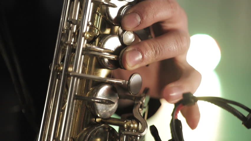 The artist plays the saxophone. Fingers press the keys of the saxophone Royalty-Free Stock Footage #1028567609