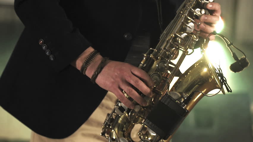 The artist plays the saxophone. Fingers press the keys of the saxophone Royalty-Free Stock Footage #1028567618