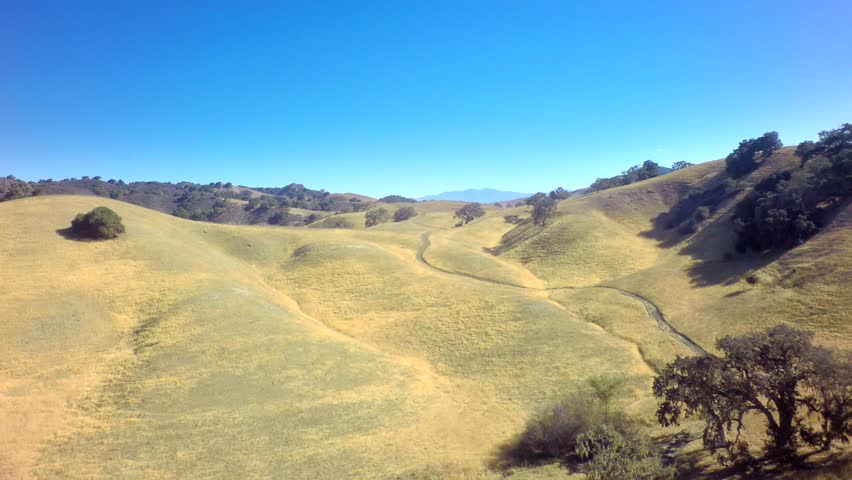 Gorgeous Mountainside Landscape Under Blue Sky by Aerial Drone