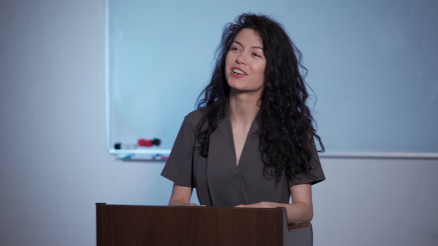 attractive curly brunette female explain lesson in school