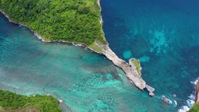 Aerial view at sea and rocks. Turquoise water background from top view. Summer seascape from air. Atuh beach, Nusa Penida, Bali, Indonesia. Travel - video