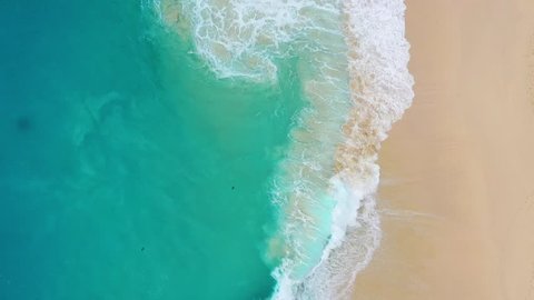 Beach as a background from top view. Waves and azure water as a background. Summer seascape from air. Bali island, Indonesia. Travel - video